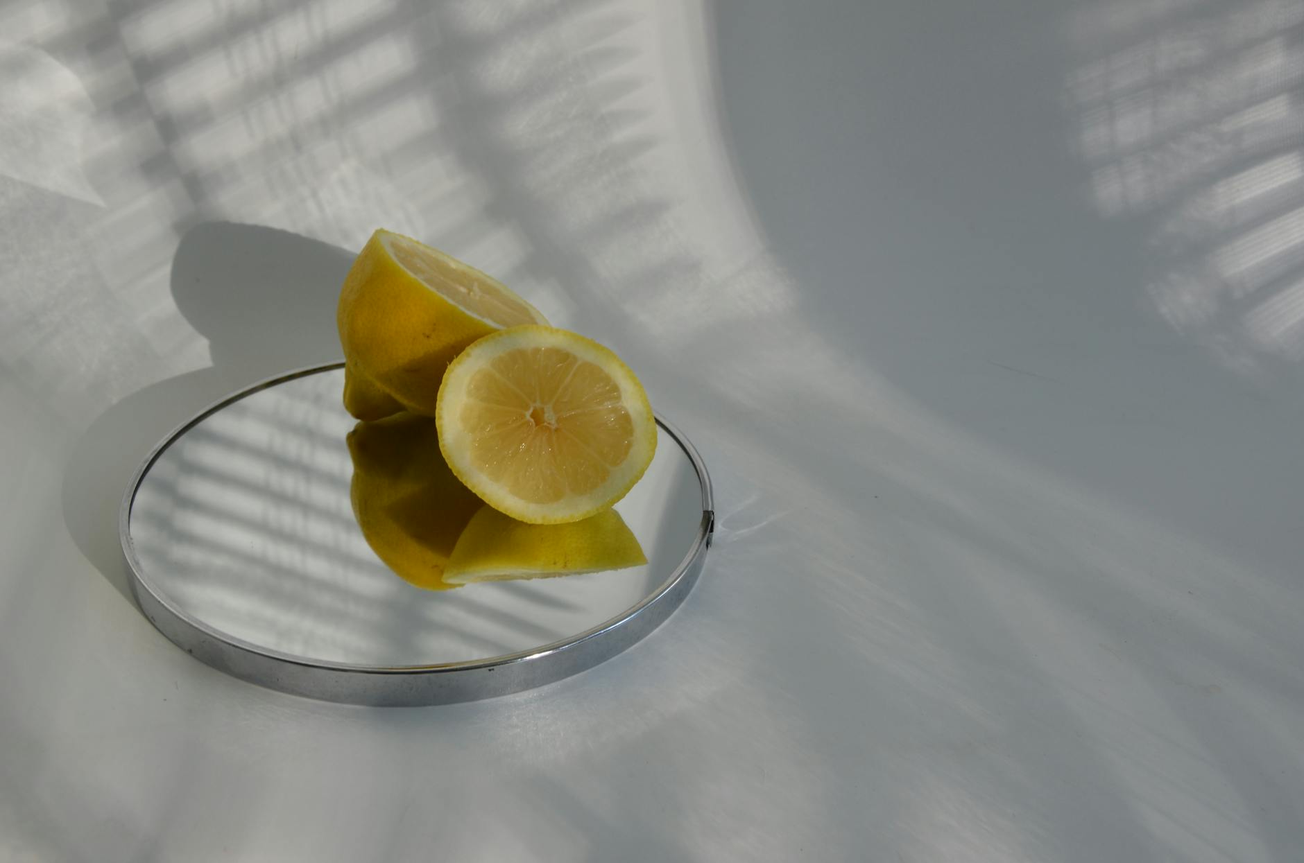 Teal clitoral vibrator on white silk fabric, representing modern intimate wellness tools