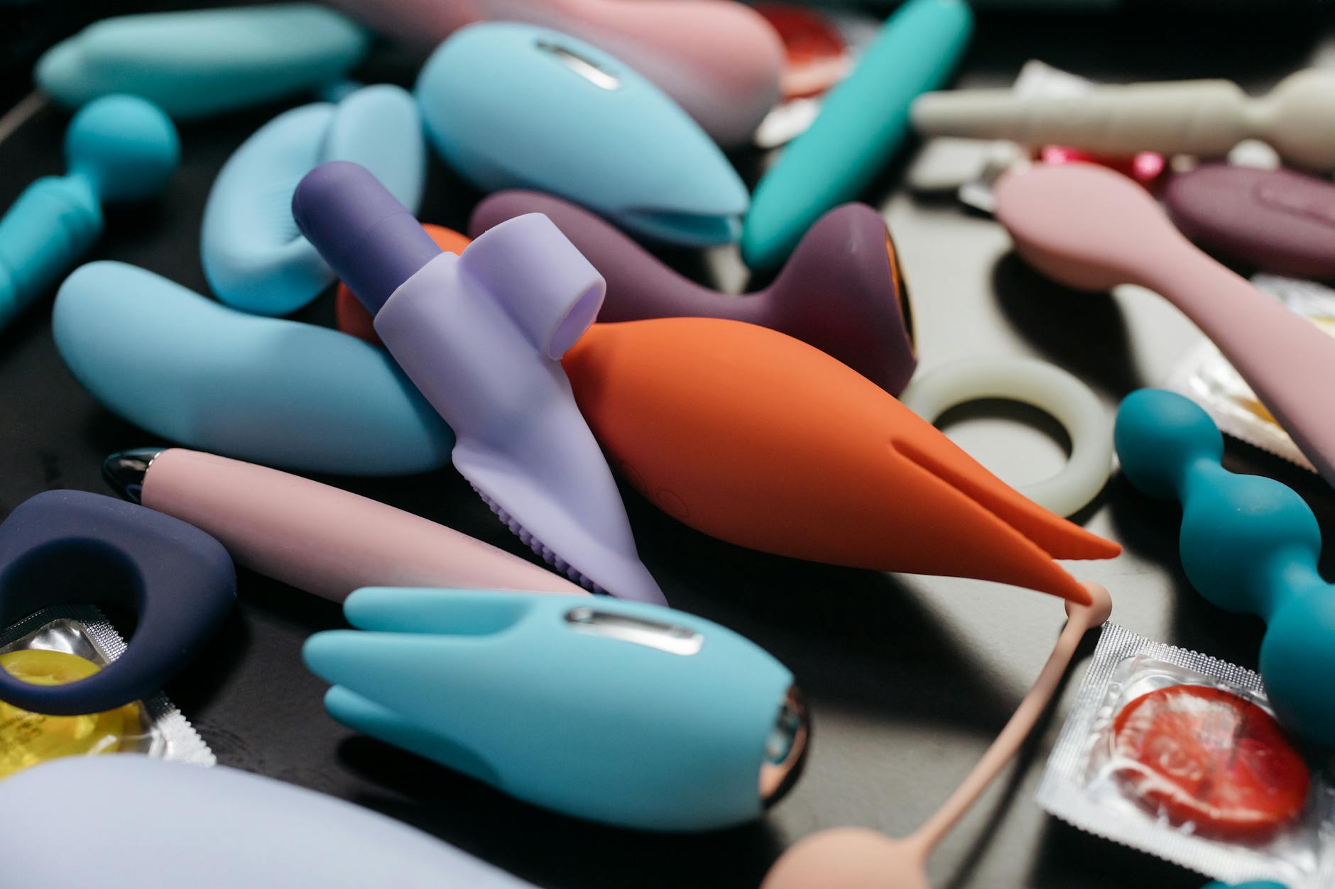 A vibrant collection of various lemon vibrators and adult toys displayed on a black tray