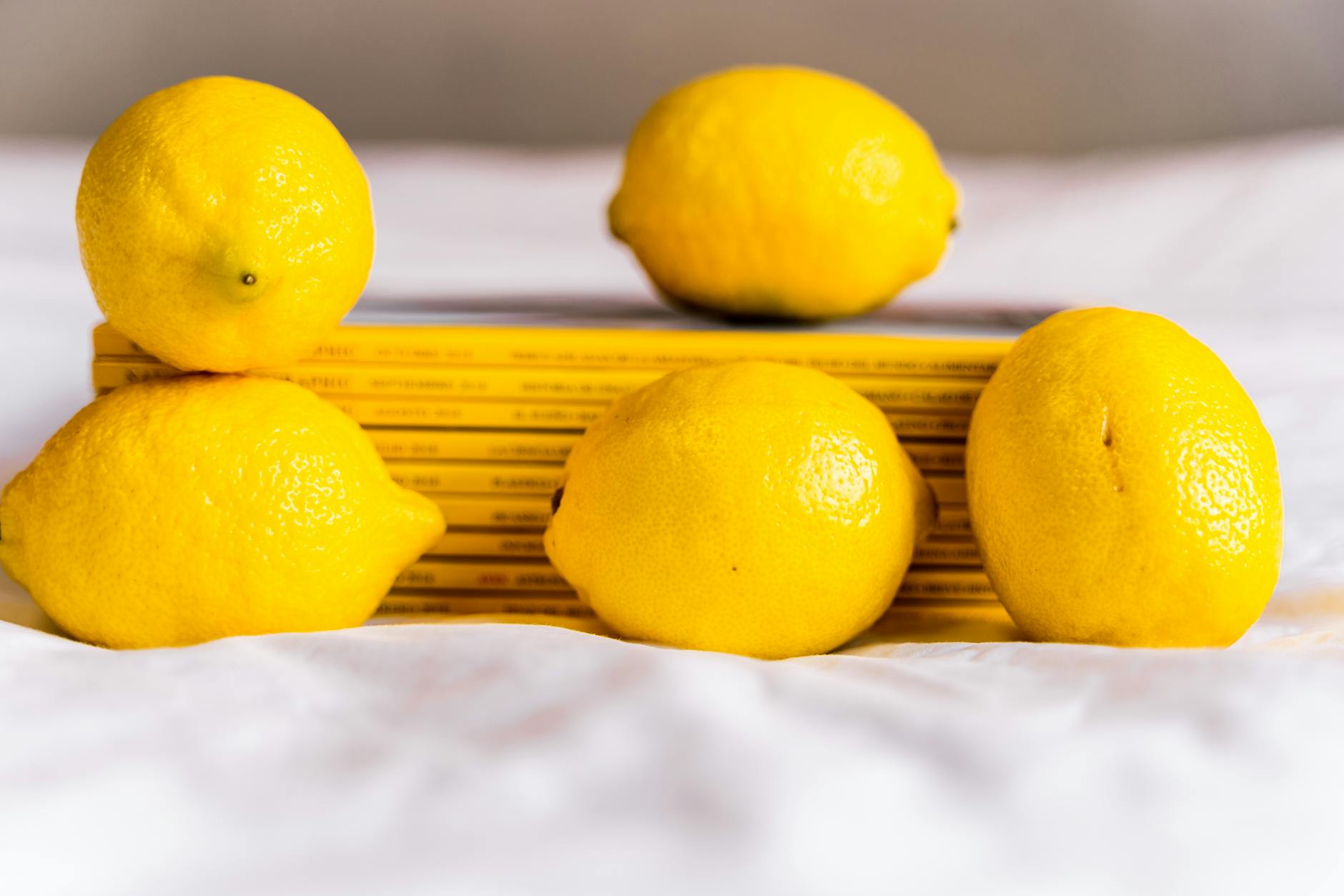 Colorful sex toys arranged on bright yellow background in studio lighting